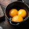 Bright yellow egg yolks set, on old dark  wooden table